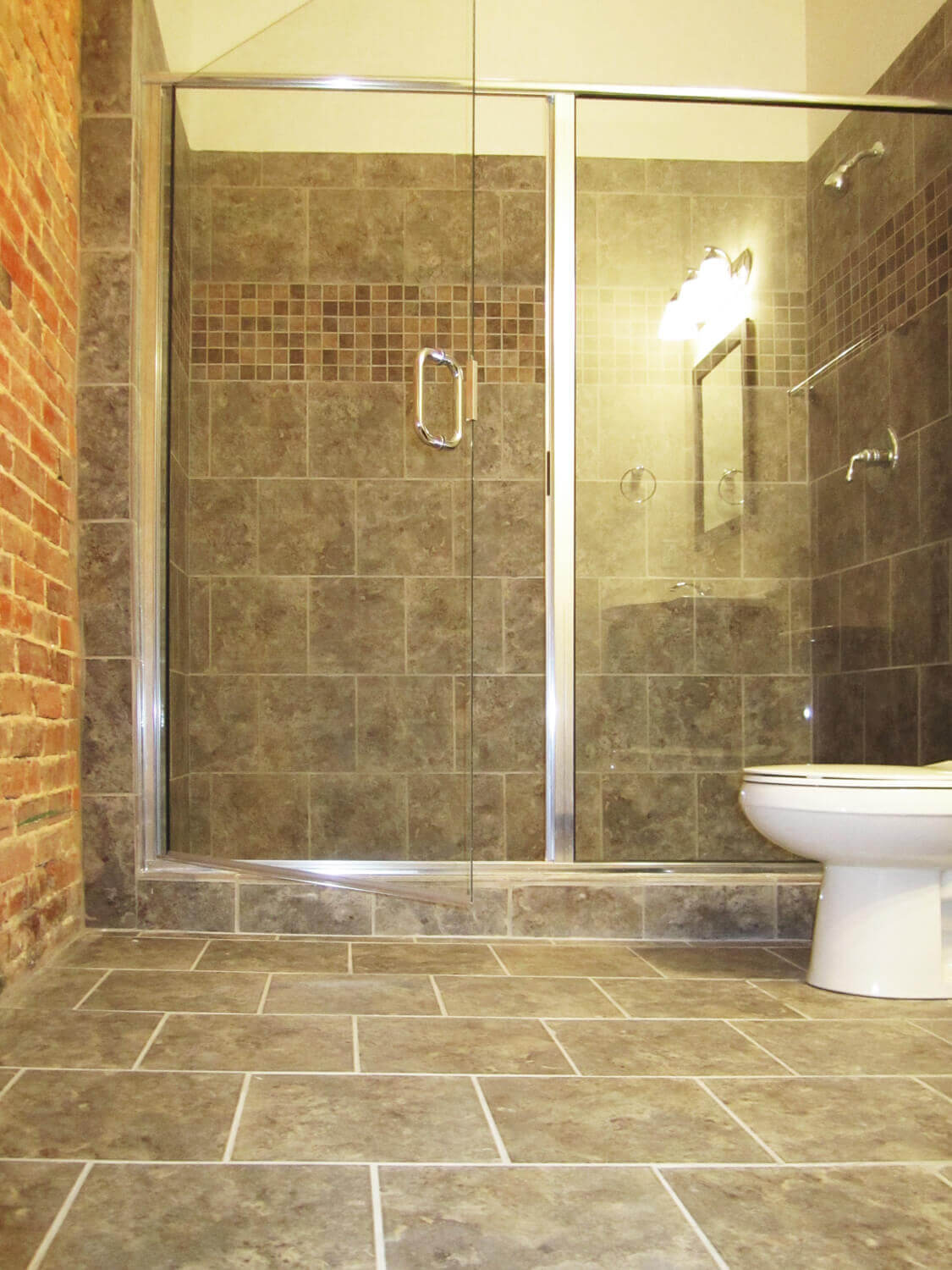 Printing Press Lofts Designed by Foshee Architecture - Apartment Bathroom with a Tile Shower